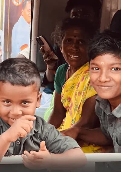 Local Family Encounter – South India Motorcycle Tour Motorcycle traveler meeting a local family during a South India motorcycle tour