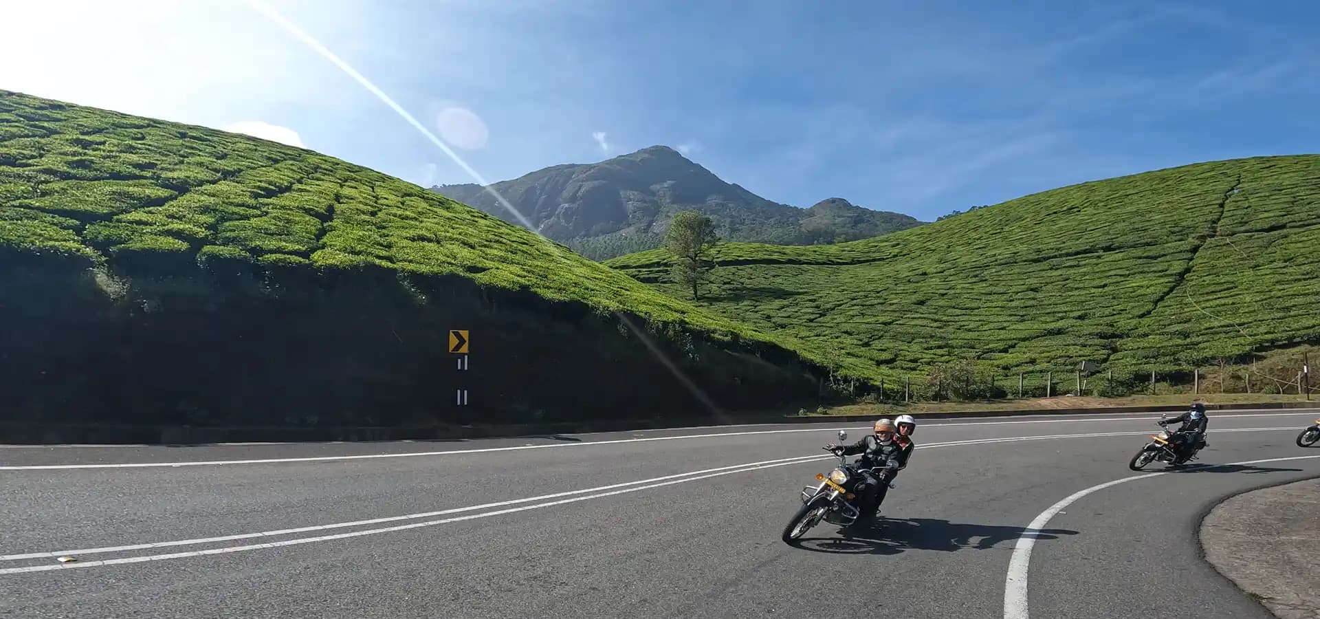 Motorcycle Tour Through South India’s Tea Plantations Motorcyclists riding through the lush tea plantations and mountain roads of South India
