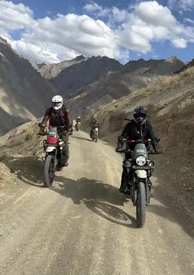 Motorcycle Adventure in Ladakh – On the Roof of the World Motorcyclists riding Royal Enfield motorcycles through the high mountains of Ladakh